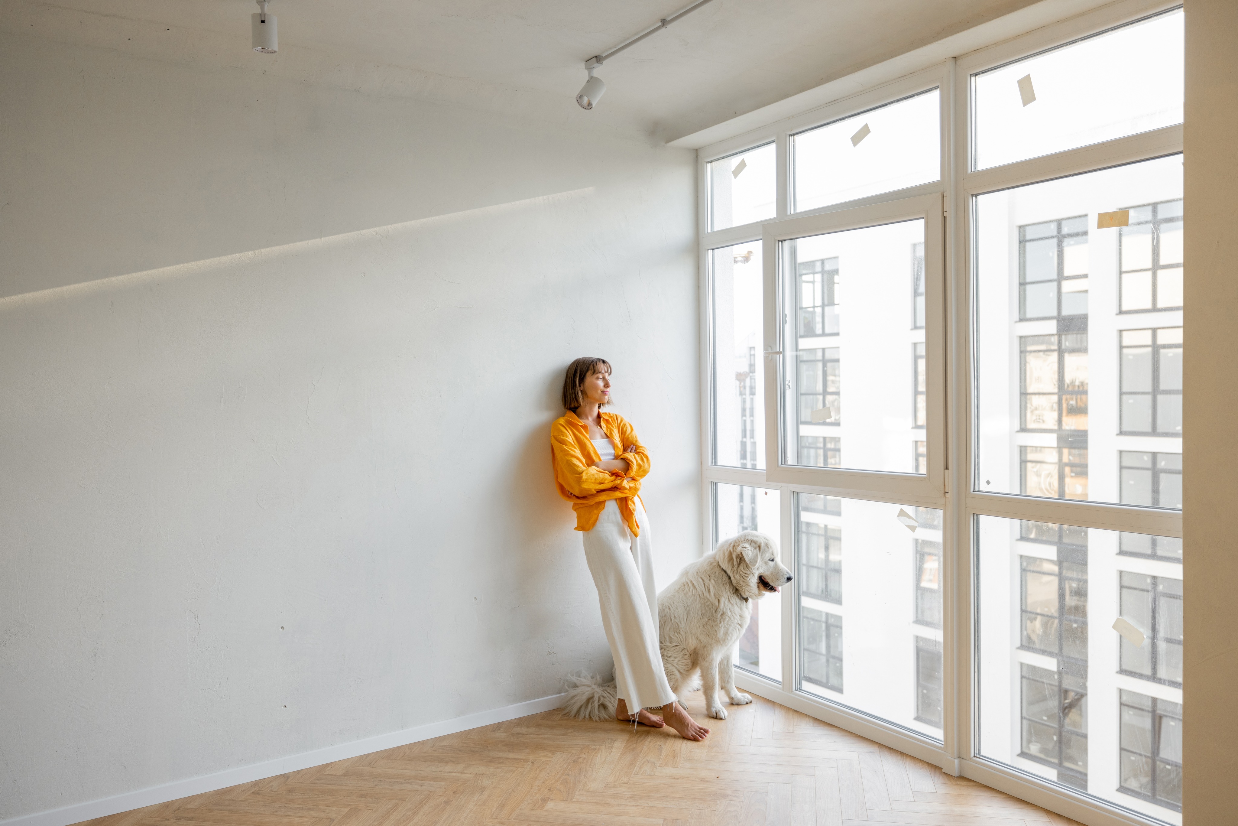 Woman with dog in new apartment