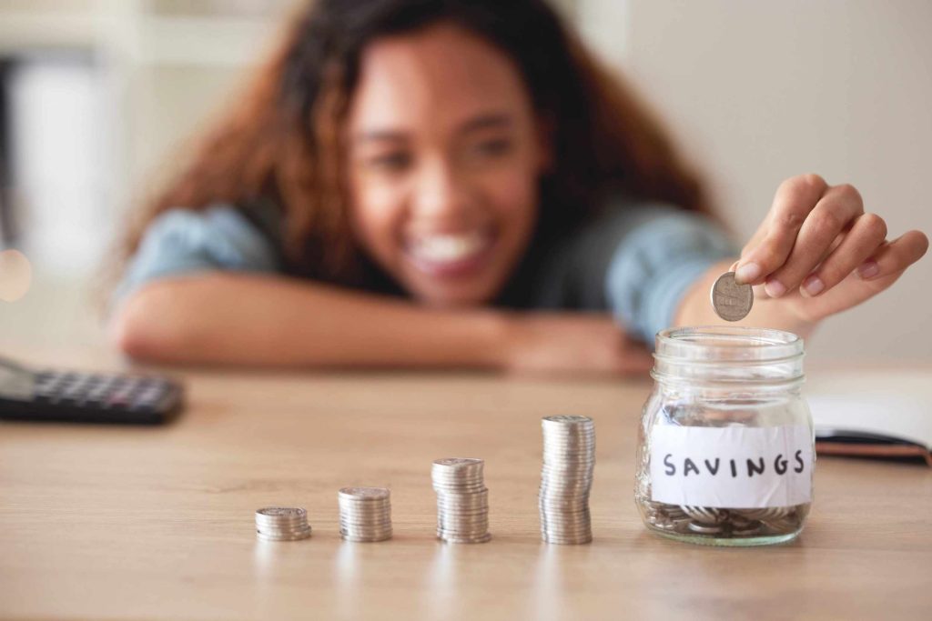 mixed race woman smiling counting her savings fro her Good Driver Reward Programs